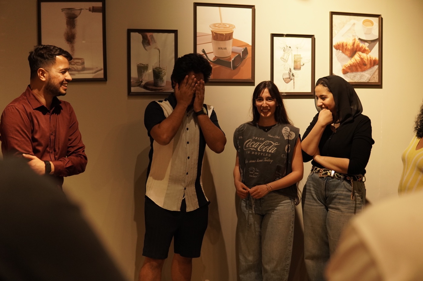 Laughing together by the gallery wall